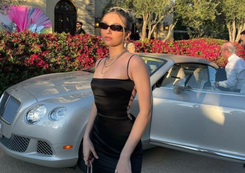 woman in black bodycon midi dress high slit with sunglasses