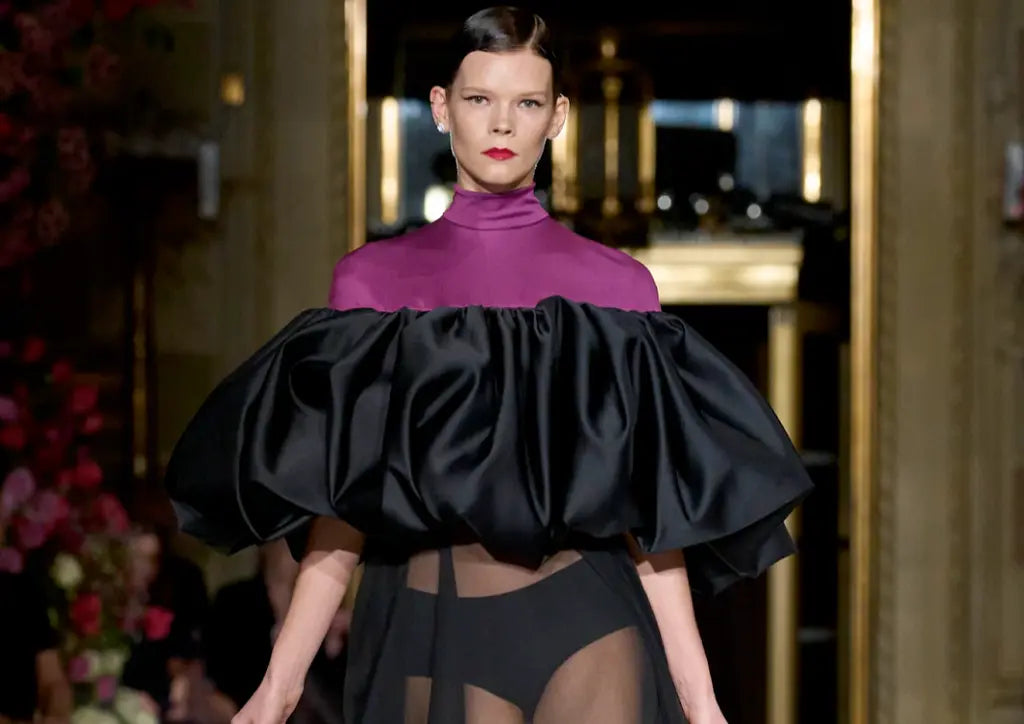 Model wearing a piece of Dress's neckline made from magenta material that flowed into a black, voluptuous satin ruching feature (1)
